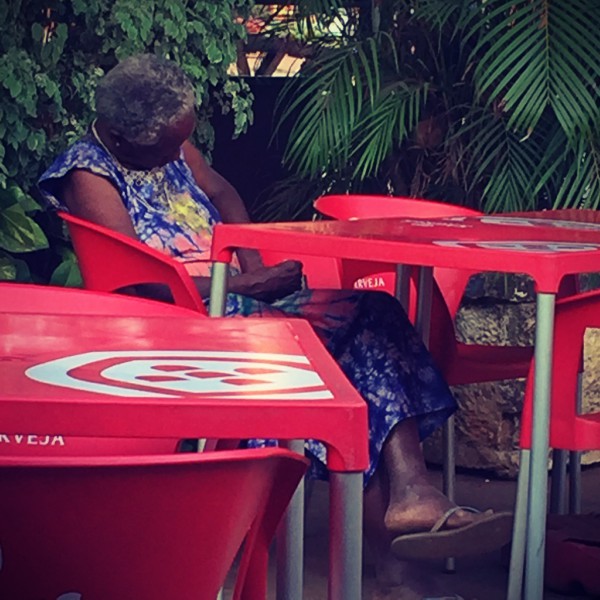 Une grand-mère vêtue de bleu dort attablée dans un café #Off2África 50 Bissau Guinée-Bissao © Gilles Denizot 2017