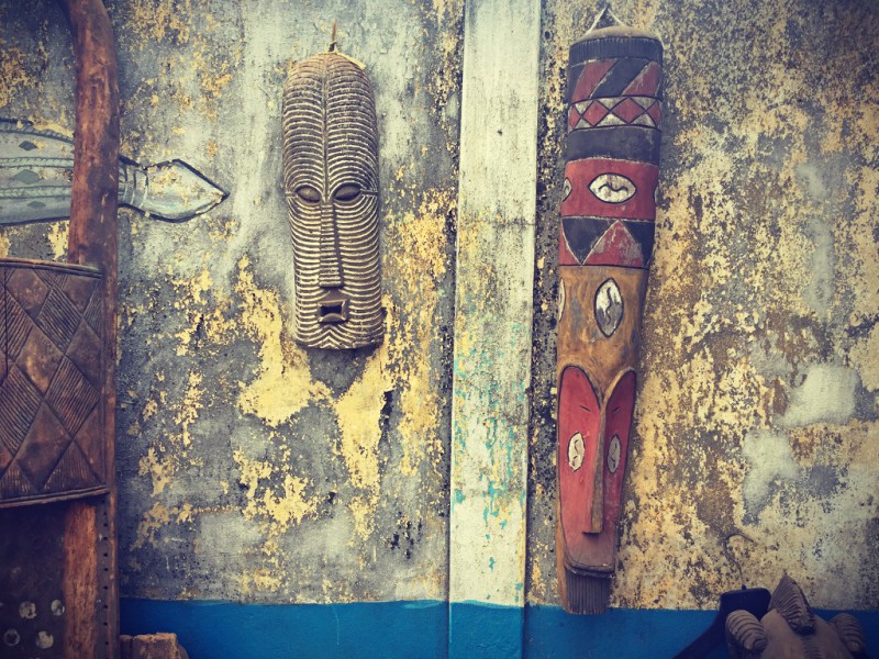 Contre un mur décrépi, deux masques africains en bois #Off2Africa 78 Conakry Guinée © Gilles Denizot 2017